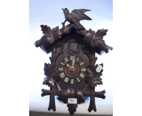 A Black Forest style carved wood cuckoo clock, 28 cm wide   Condition report  Report by GHSome chips to leaves and foliage.  