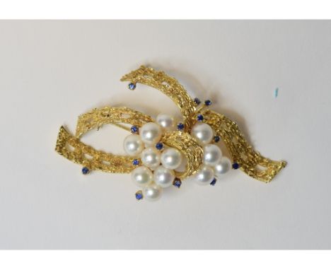 A 14ct gold, pearl and sapphire scroll brooch