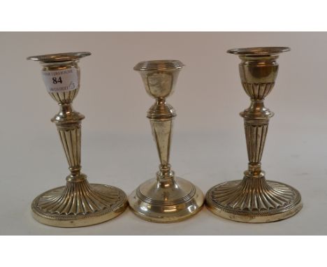 A pair of Victorian silver candlesticks, on spreading oval bases, Sheffield 1897, 16.5 cm high, and another silver candlestic