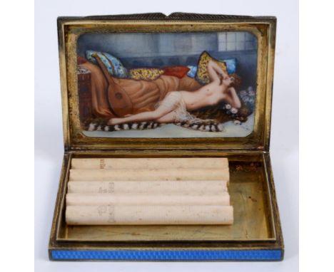 A silver and enamel cigarette case, the exterior with engine turned decoration and blue enamel, the inside cover revealing a 