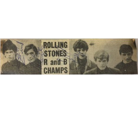 ROLLING STONES - KEITH, MICK AND CHARLIE SIGNED. A newspaper cutting signed in blue ink by Keith Richards, Mick Jagger and Ch