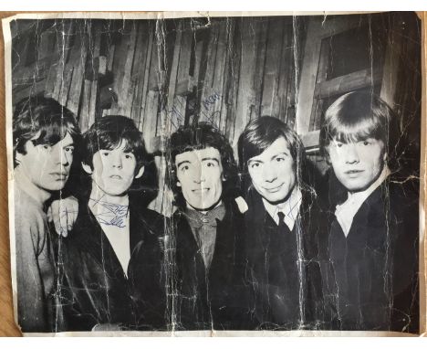 ROLLING STONES SIGNED IMAGE. A 35 x 28cm black and white printed image of the Rolling Stones signed in blue ink by Bill Wyman
