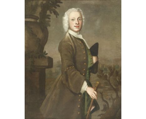 Circle of Thomas Hudson (1701-1779)PORTRAIT OF A YOUNG GENTLEMAN, THREE-QUARTER LENGTH STANDING, IN A BROWN COAT, AND HOLDING