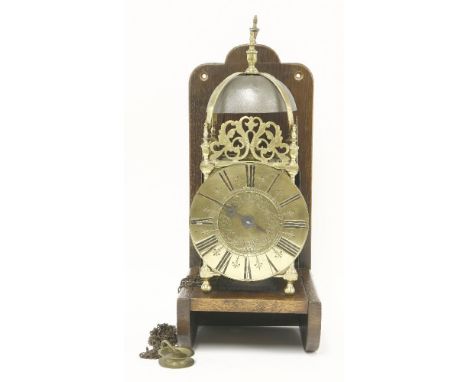 A brass lantern clock,18th century and later, with a verge escapement striking on a bell,39cm highdial 17.5cm diameter