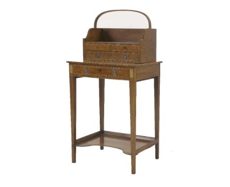An inlaid mahogany cheveret,early 19th century, the lift-off tray with galleried shelf and three drawers, square tapering leg