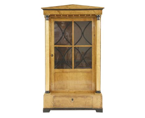 A Biedermeier birch cabinet,c.1830, having an architectural pediment and ebonised mounts,101cm wide48cm deep178.5cm high
