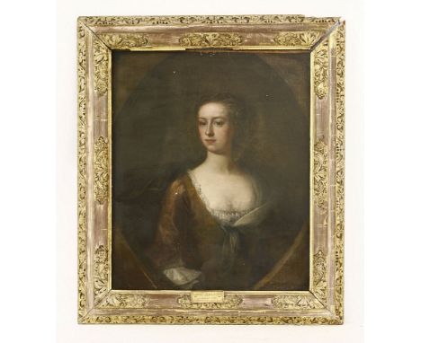 Circle of John Vanderbank (1694-1739)PORTRAIT OF A LADY, HALF LENGTH, IN A GOLD DRESSOil on canvas, painted oval76 x 63cm, in