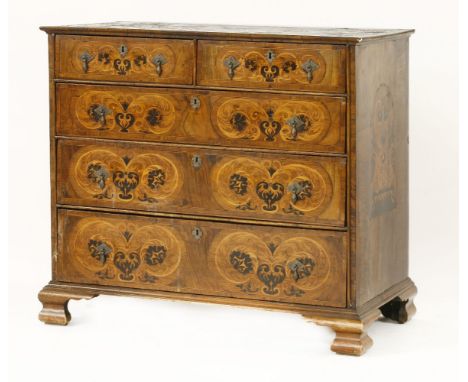 A marquetry chest of drawers, early 18th century, of two short and three long drawers, inlaid with urns and floral details, t