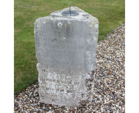 A triangular stone column,bearing a Latin inscription to two sides, dated 1854, now with a later sundial,88cm high46cm wide