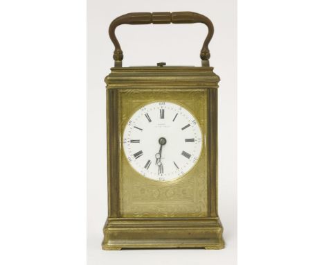 A brass carriage clock,  the repeating mechanism striking the hours and half-hours on a gong, the circular enamel dial inscri