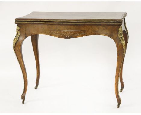 A walnut and gilt-mounted card table,late 19th century, the serpentine front with a fold over top opening to reveal a baized 