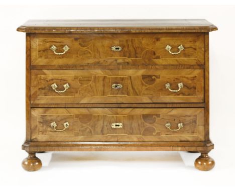 A German inlaid walnut commode,18th century, the top with a geometric inlaid panel, over three strung and crossbanded drawers