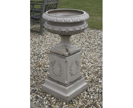 A stoneware garden urn,19th/20th century, the lobed bowl on a square pedestal base,104cm high