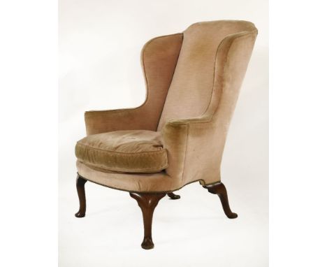 A George I wing armchair,with outscrolled arms on walnut pad foot front legs and outswept rear legs,109cm high