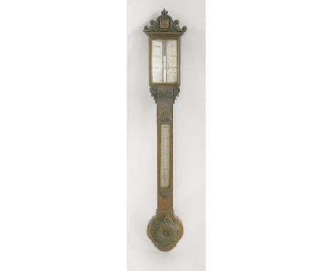 A Victorian oak stick barometer,by Dollond, London, carved with an heraldic shield crest, the silvered register plates angled