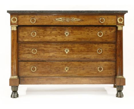 A French Empire commode,early 19th century, the grey marble top over four long drawers, with ring handles within turned colum