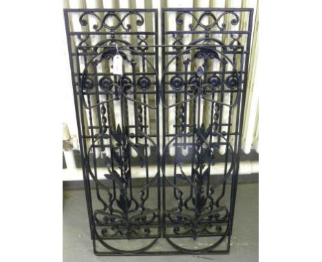 A PAIR OF BLACK PAINTED CAST IRON ORNAMENTAL PANELS AND A DECORATIVE BLACK POWDER COATED STEEL PANEL