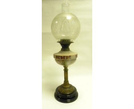 A VICTORIAN BRASS OIL LAMP WITH PAINTED GLASS FOUNT, ON BLACK POTTERY BASE WITH ETCHED GLASS LAMPSHADE
