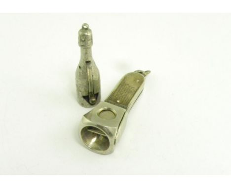 A FRENCH NICKEL PLATED BRASS CHAMPAGNE BOTTLE NOVELTY CIGAR CUTTER AND A CIGAR CUTTER WITH ENGINE TURNED SILVER SCALES