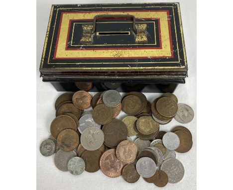A small vintage metal cash tin with carry handle, containing a collection of vintage British and foreign coins. To include ex