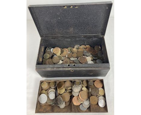 A vintage black metal cash tin containing a collection of vintage British and foreign coins. To include examples from Barbado