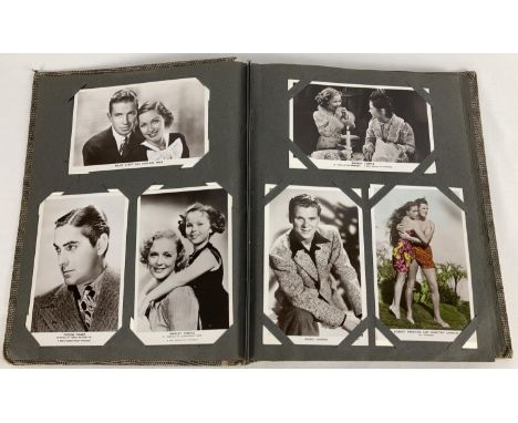 A vintage postcard album containing a collection of film studio black and white and coloured photographic postcards of 1930's