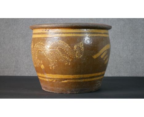 A Chinese earthenware dragon glazed garden planter. H.37.5 Diam.49cm 