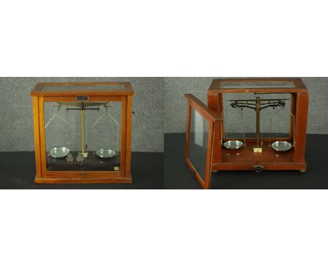 Two sets of Griffin &amp; George Limited scientific scales, with chrome pans, in glazed case with two sets of weights. H.40 W