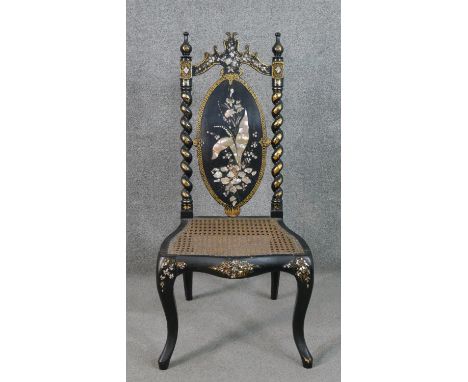 A Victorian black lacquered side chair, the oval back inlaid with mother of pearl to form a flower, flanked by rope twist sup