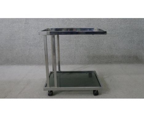 A vintage chromed metal cantilever trolley, the square section tubular frame supporting two tiers of smoked glass. H.48 W.61 