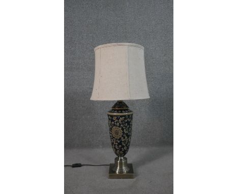 A Chinese style hand painted ceramic lamp with stylised floral design on a brushed metal base. H.79 Diam.36cm 