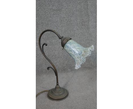 An Art Nouveau style brass table lamp in the form of a flower, with green and blue marble glass bell shaped shade. H.39 W.28c