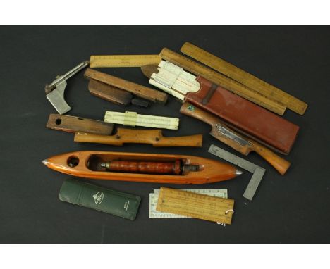 A collection of woodworking tools, including rules, planes and other measuring implements. L.42 (largest) 