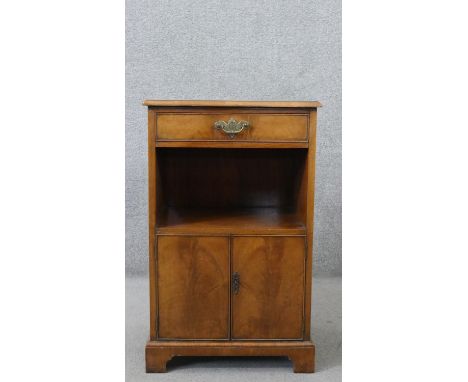 A 20th century George III style bedside cabinet, the top with a tooled blue/green leather inset, over a single drawer, above 