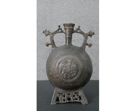 A Balkan 15th century style flask with St George motif to the middle and animal design to the pierced base. H.29 W.21cm 