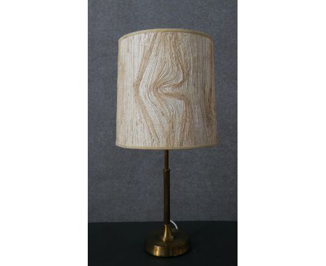 A mid 20th century Swedish brass lamp by EWA Belysning of Varnamo, with a columnar stem, cast maker's marks to the underside,