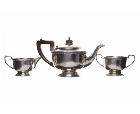 GEORGE V SILVER THREE PIECE TEA SERVICEmaker Lanson Ltd, Birmingham 1934, of circular form, teapot with wooden finial and han