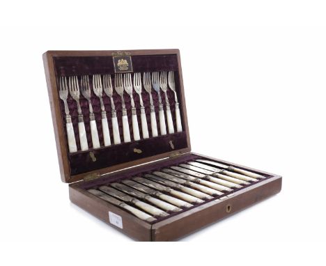 SET OF TWELVE MOTHER OF PEARL HANDLED FISH KNIVES AND FORKS the blades and terminals plated, in fitted mahogany canteen label