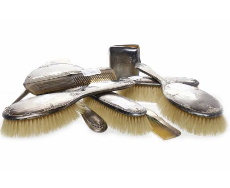 TWO SILVER BACKED VANITY SETSthe first Birmingham 1925-26, comprising two hair brushes, hand held mirror, clothes brush and c