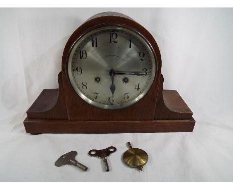An oak cased mantel clock