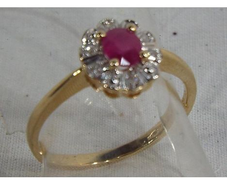 A lady's 9 carat gold ring set with centre ruby and diamond cluster, size L and a half, approximate weight 1.86 grams, boxed.