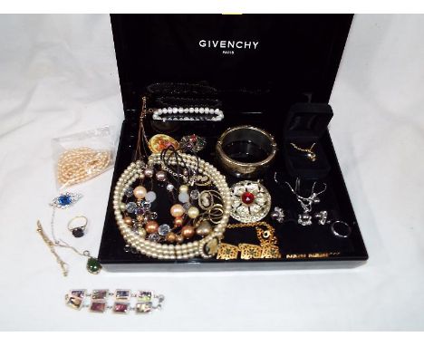 A Givenchy black box containing a collection of good quality costume jewellery to include cultured pearls, sea pearls, brooch