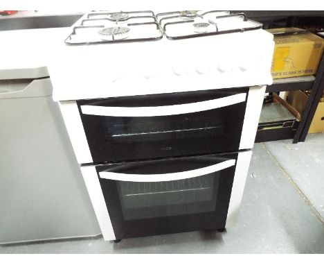 A Logik free standing twin cavity gas cooker, nominal use only, model number LFTG 60W12 93cm (h) x 60cm (w) x 69cm (d) with m