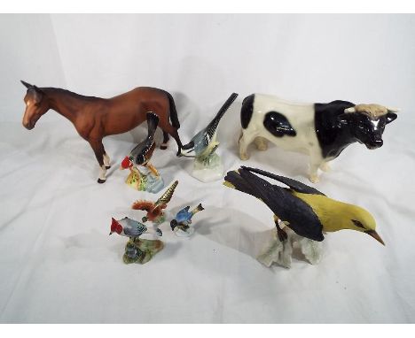 A mixed lot of ceramic figures to include a Beswick pottery mare, a Goebel figure depicting a golden oriole, a Friesian bull 