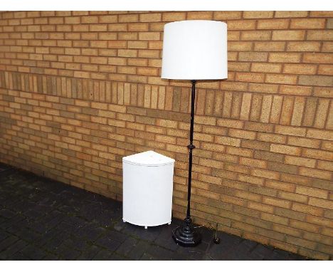 A standard lamp and a Lloyd Loom linen basket
