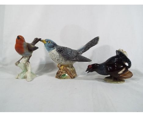 A Beswick pottery figure depicting a cuckoo #2315, a Goebel figure depicting a turkey and a further figure depicting a robin 