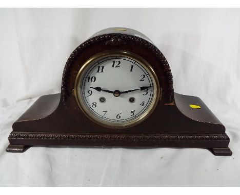 A carved mantel clock with pendulum and H & B movement D.R.G.M No. 916380