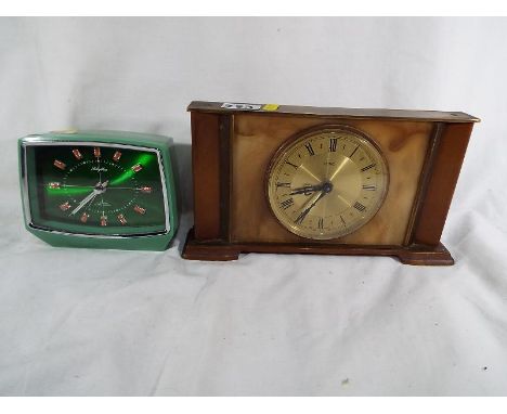 A vintage Metamec mantel clock with wind-up movement and a rhythm 2 jewel alarm clock No. 51163 with wind-up movement (2)