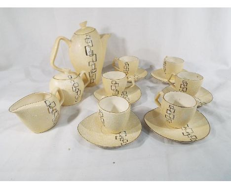 A mid-century stylised coffee set consisting of coffee jug, milk jug and sugar bowl and six cups and saucers, decorated with 