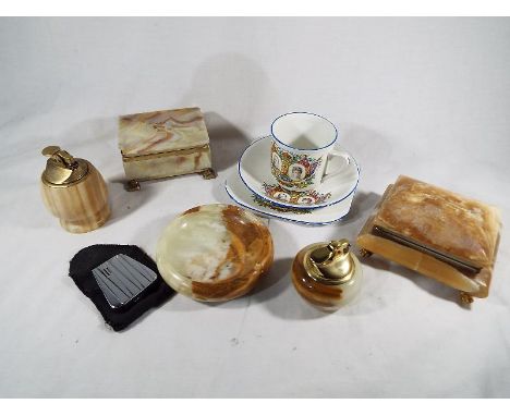 A collection of onyx comprising two cigarette lighters, ashtray, trinket box and card box, a Ronson lighter and a Royal comme